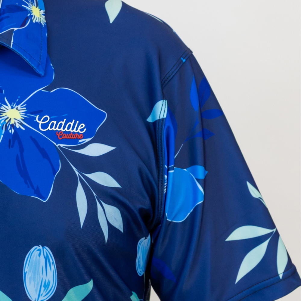 Blue floral patterned shirt with 'Caddie Couture' branding on a white background