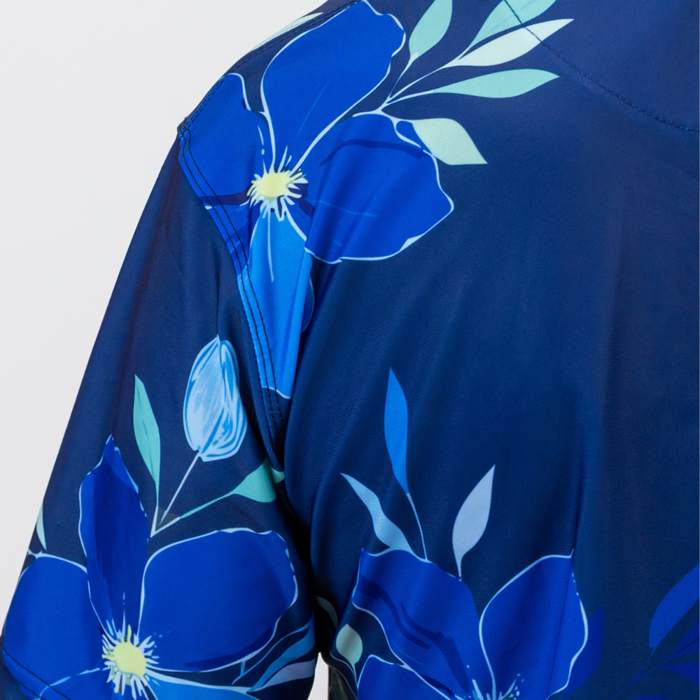 Blue floral pattern on a garment against a light gray background