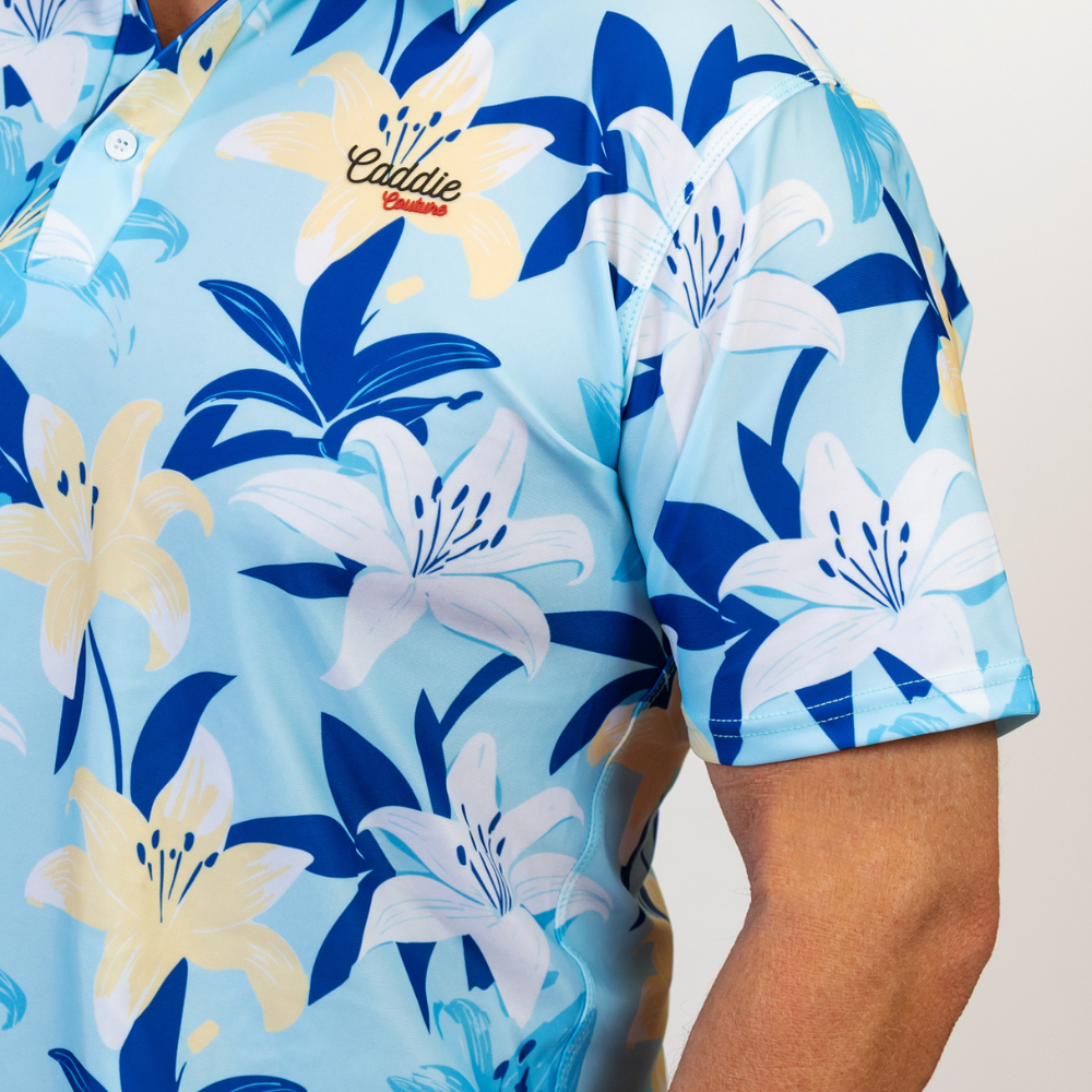 Floral patterned shirt with blue, white, and yellow flowers on a light blue background.