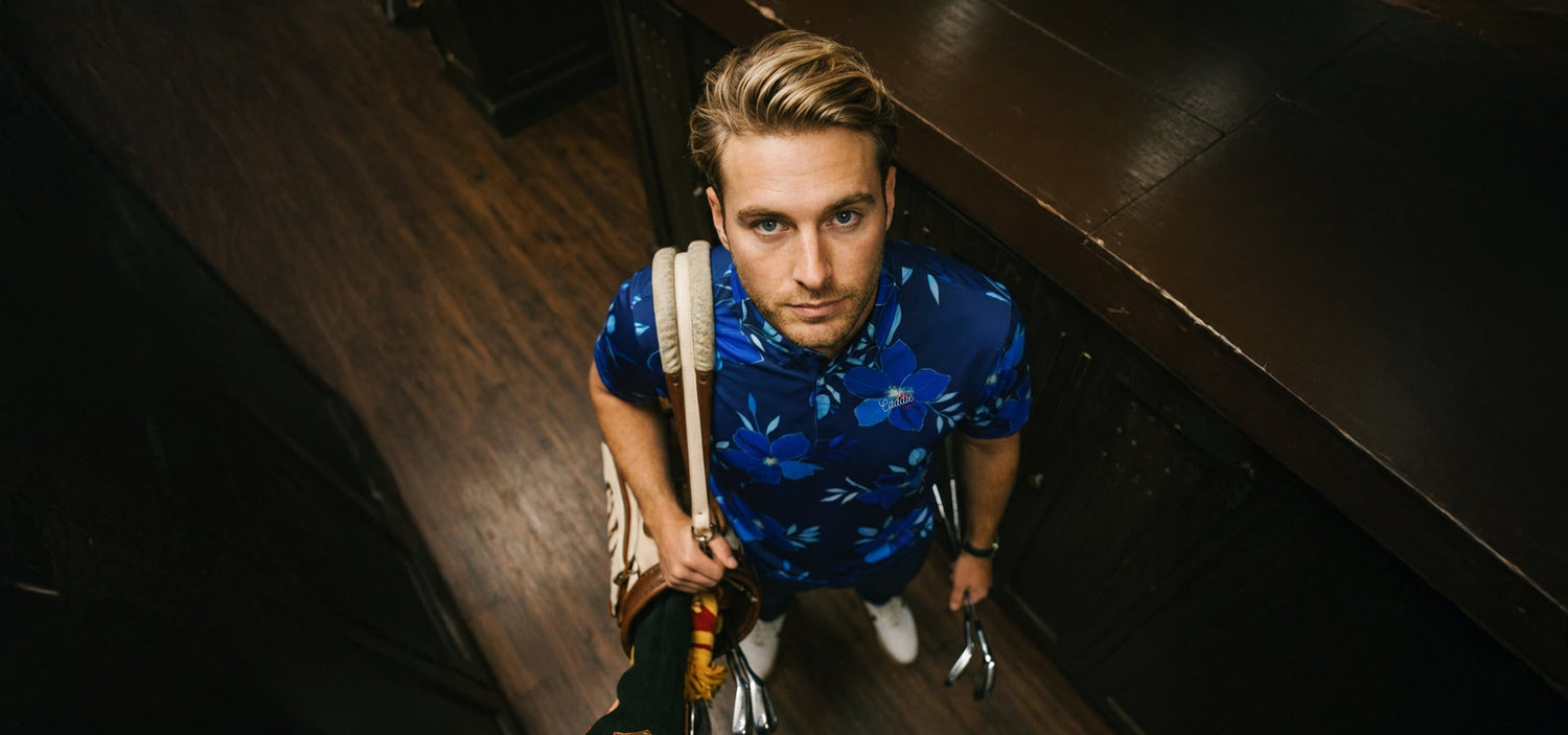 Man wearing blue floral polo in locker room from a Birdseye view