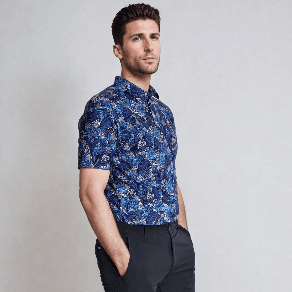 Model standing on his side wearing blue floral golf polo
