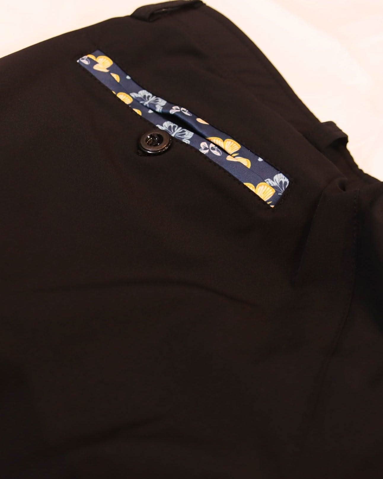 close up of golf joggers pocket with butterfly detailing