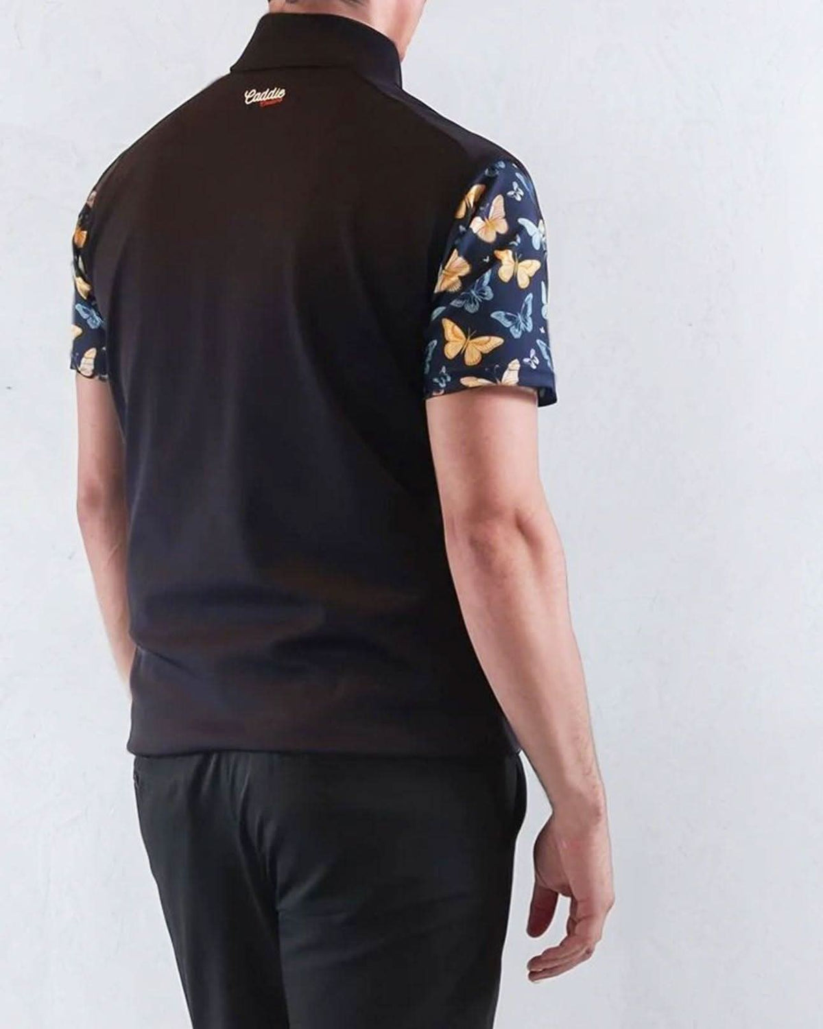 Person wearing a Navy Golf Vest with butterfly pattern sleeves on a white background