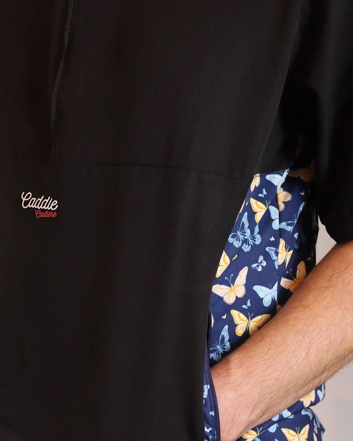 Black jacket with a butterfly patterned lining and 'Caddie' branding.
