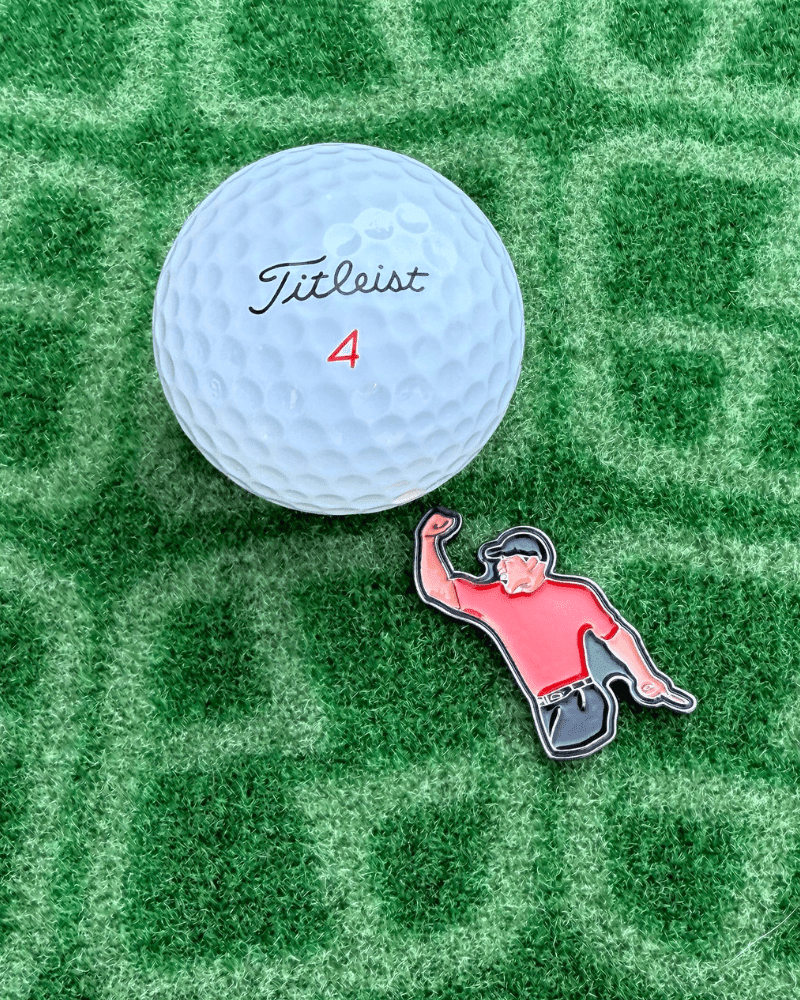 Tiger Woods Golf Ball Marker next to golf ball