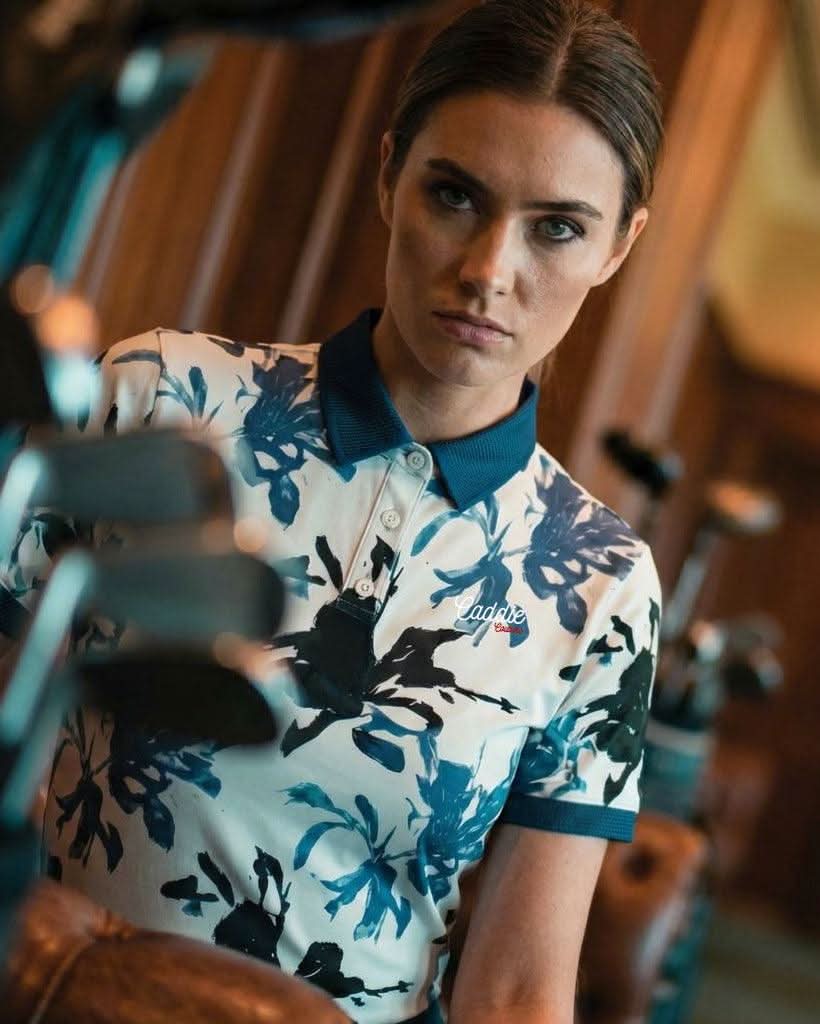 Person wearing a floral polo shirt with a blurred background