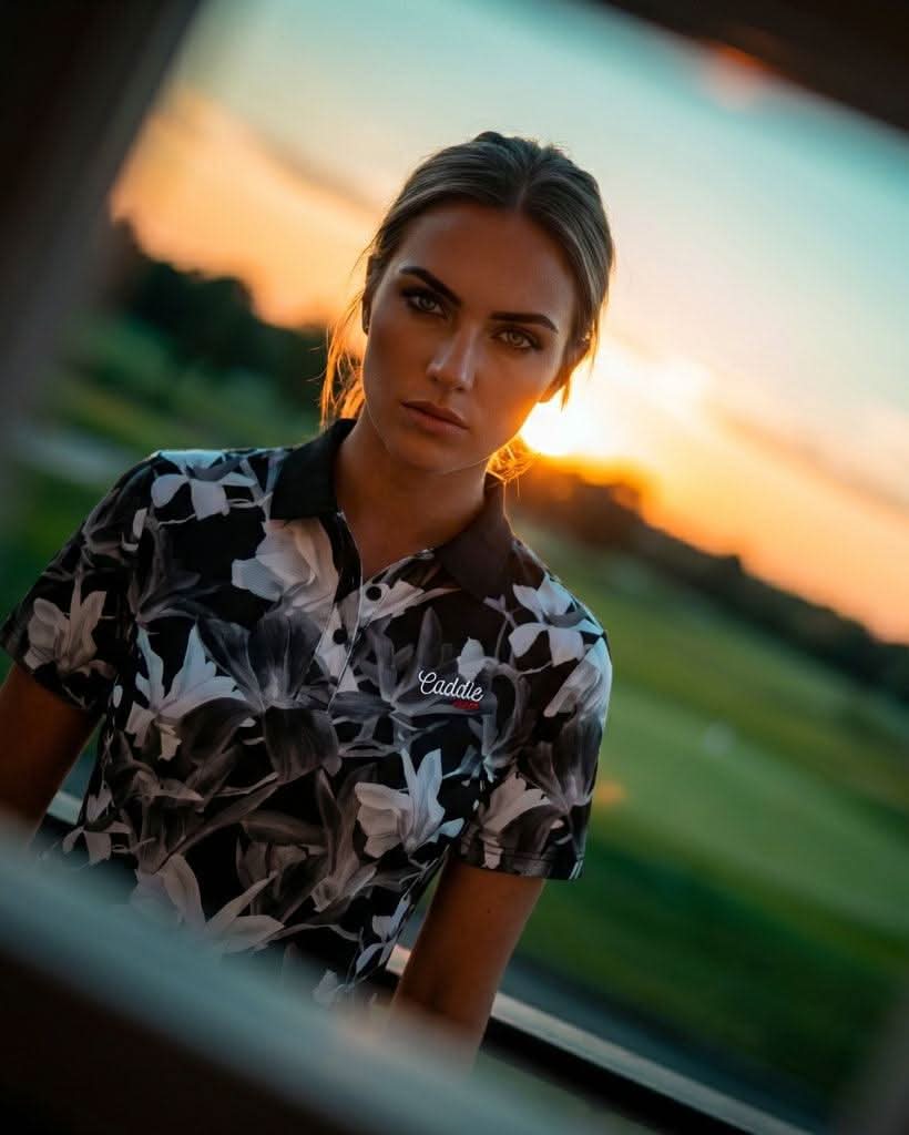 Woman wearing a patterned shirt with a sunset in the background