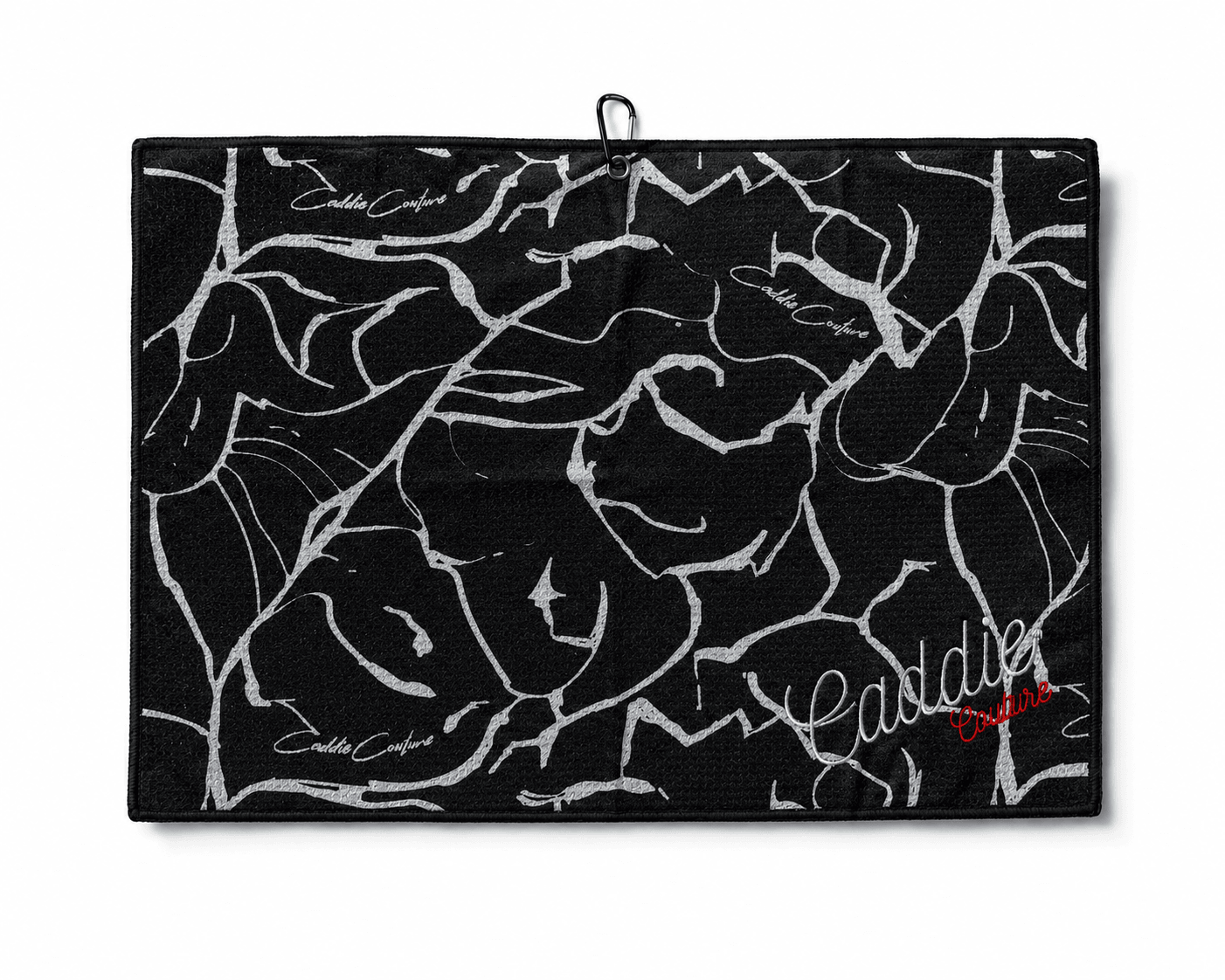 Black towel with white floral pattern and 'Casadei' branding on a white background