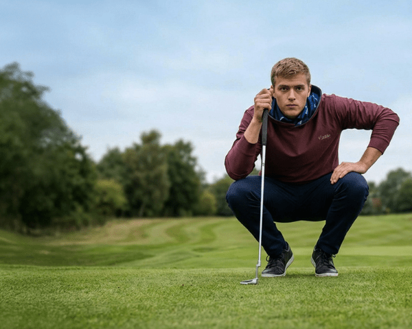 man reading a put with caddie couture hoodie on