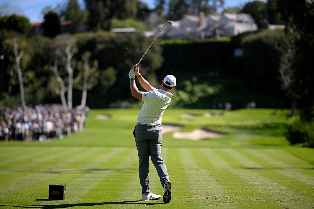 Golfer swinging a club on a golf course