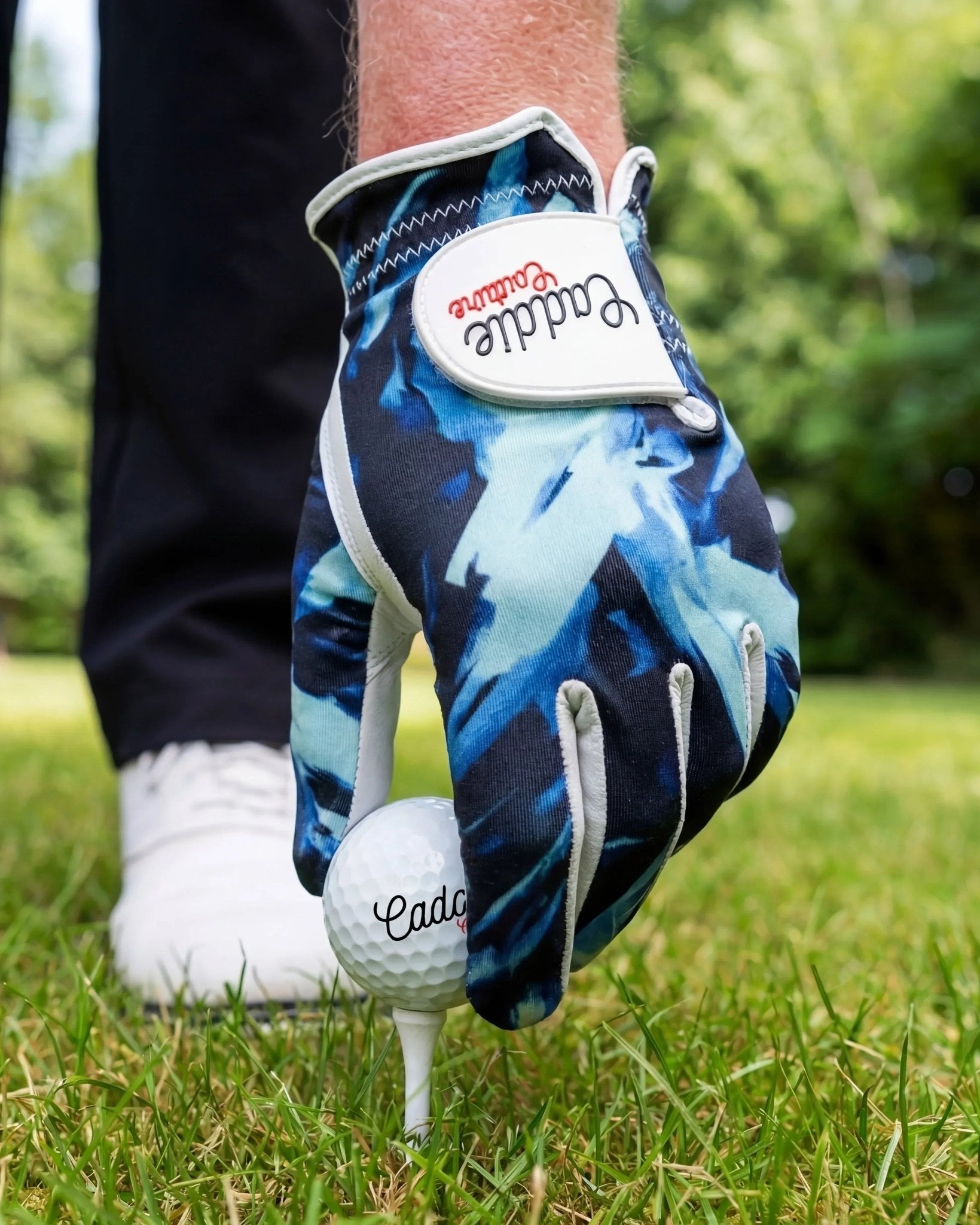 Golf glove putting ball on a tee