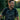 man wearing green golf polo looking at the camera