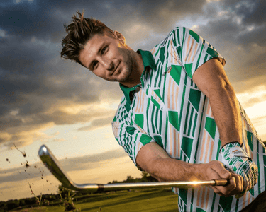 man wearing green golf polo looking at the camera