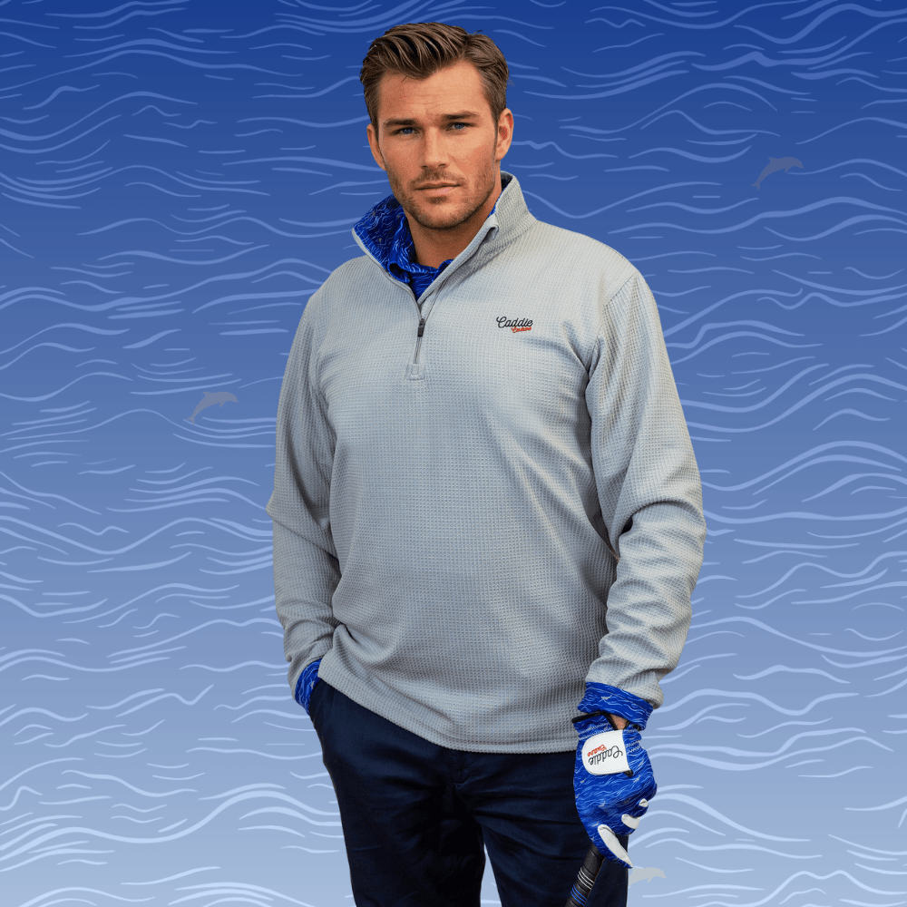 man wearing golf quarter zip holding golf club