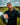 Man holding a golf club on a golf course with a cloudy sky