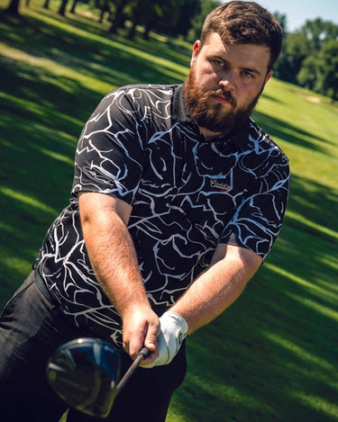 Man playing golf on a green course