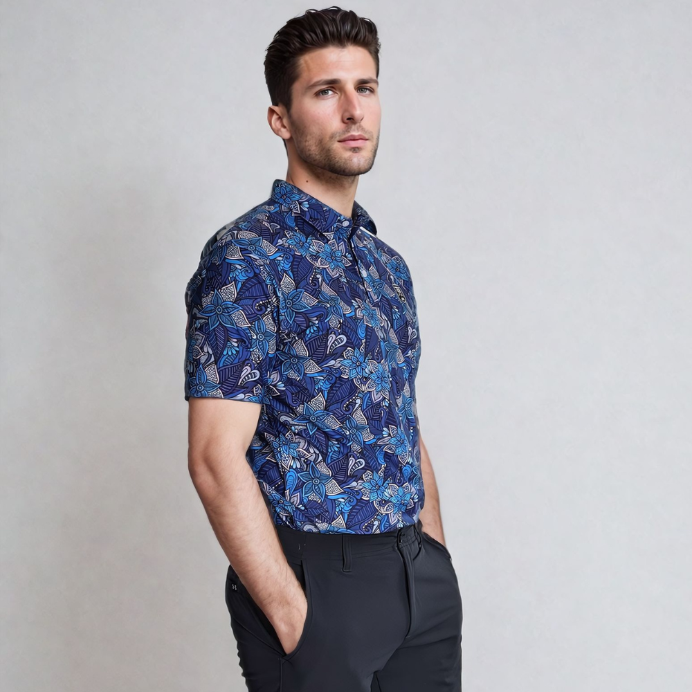 Model standing on his side wearing blue floral golf polo