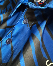 Close-up of a blue and black patterned shirt with buttons.