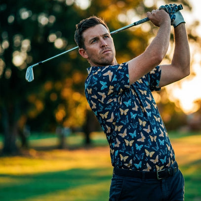 man wearing butterfly golf polo swinging golf club