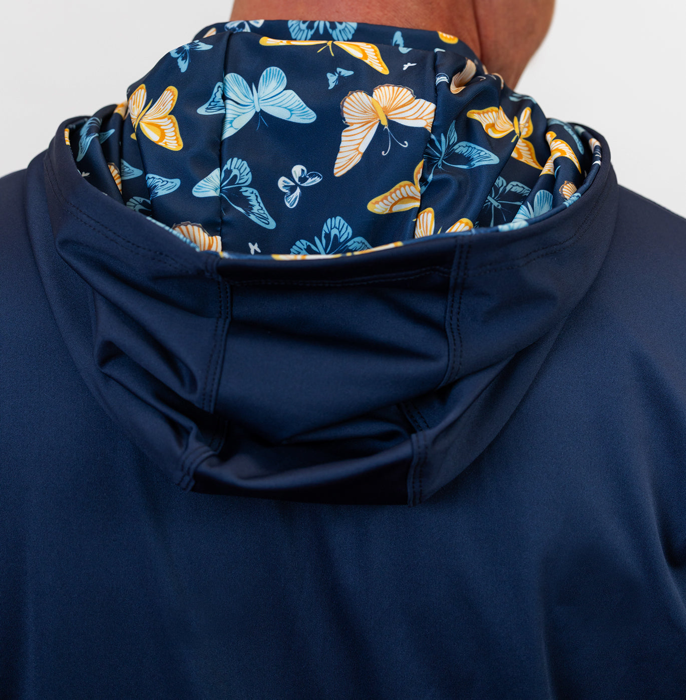Navy blue golf hoodie with a butterfly pattern on the hood