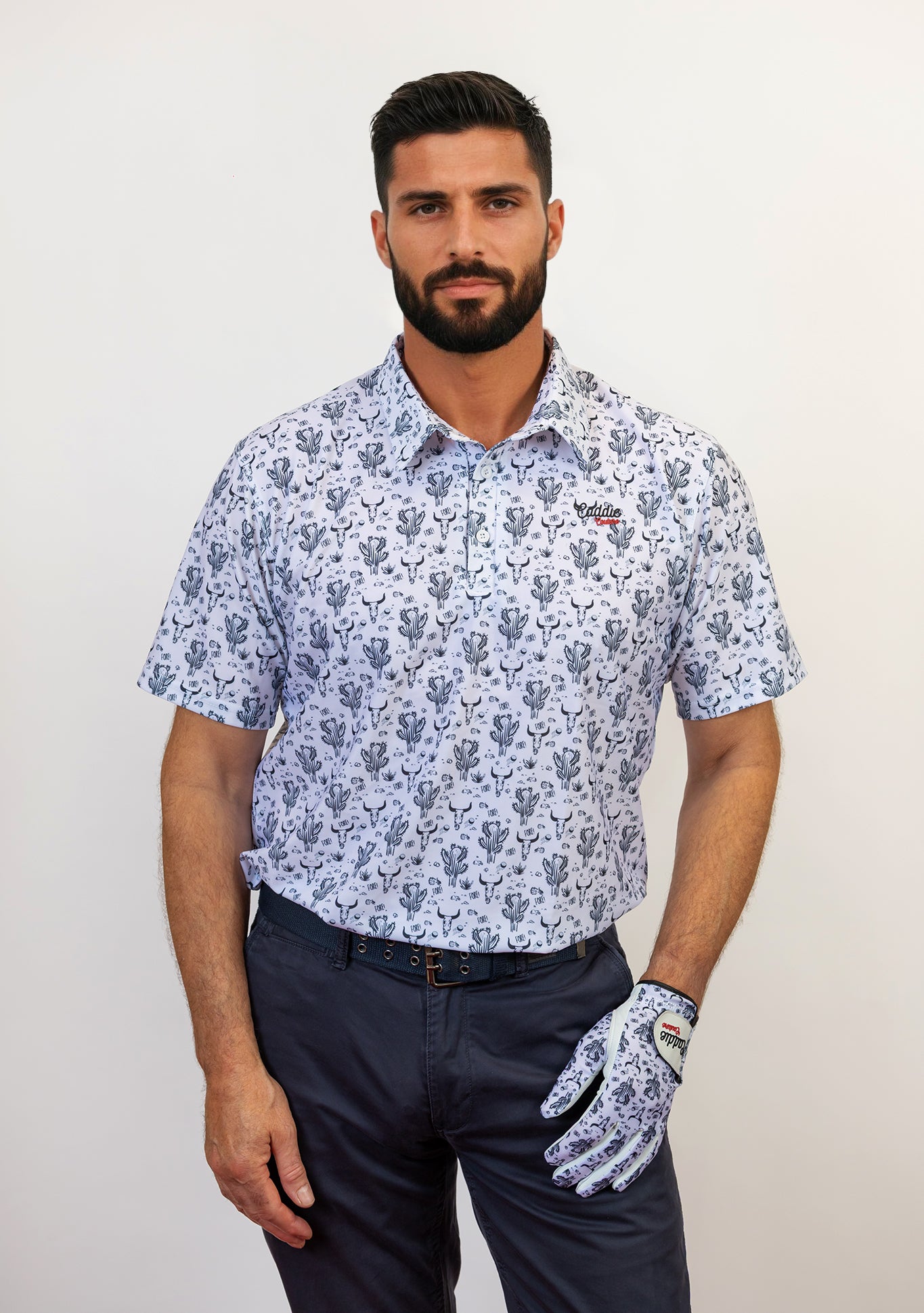 Man wearing a patterned shirt and golf glove on a plain background