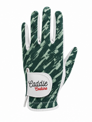 A single golf glove from Caddie Couture featuring a dark green and light green brushstroke pattern with white trim and a white wrist strap.