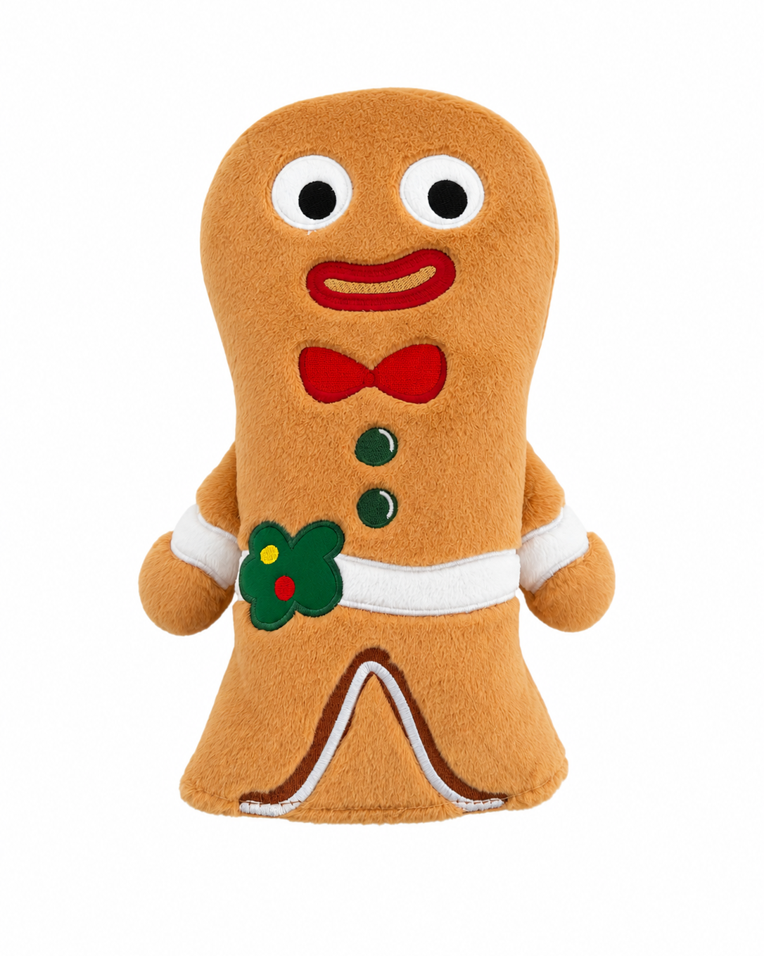 A gingerbread man plush toy with a soft tan body, white trim, a red bow tie and mouth, green buttons, and a green holly accent on the chest, shown on a plain white background.
