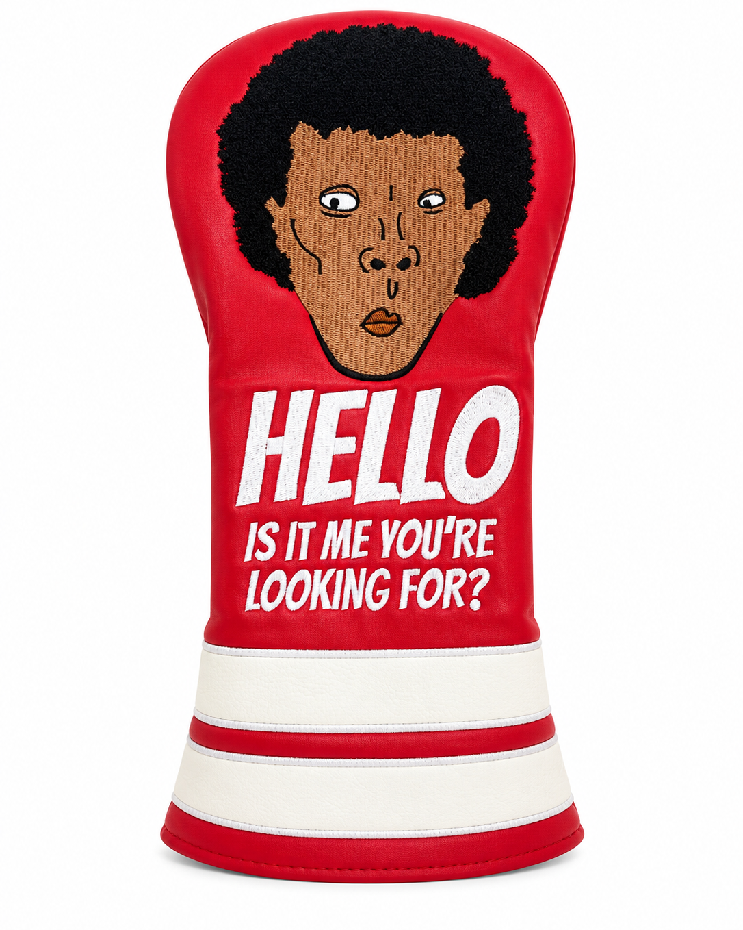 A red golf club headcover featuring a graphic of a Lionel Ritchie with an afro and the text 'HELLO IS IT ME YOU'RE LOOKING FOR?' in white, with white horizontal stripes at the bottom.