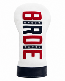 A white golf club headcover with a bold vertical 'BRO' design in red and navy blue, featuring decorative star stripes and a dark navy base.
