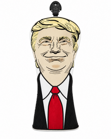 A novelty headcover shaped like a cartoon portrait of Donald Trump, featuring blond hair, a black suit jacket, white shirt, and red tie, shown on a plain white background.
