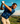Man playing golf on a scenic course with mountains in the background