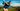 Man playing golf on a scenic course with mountains in the background