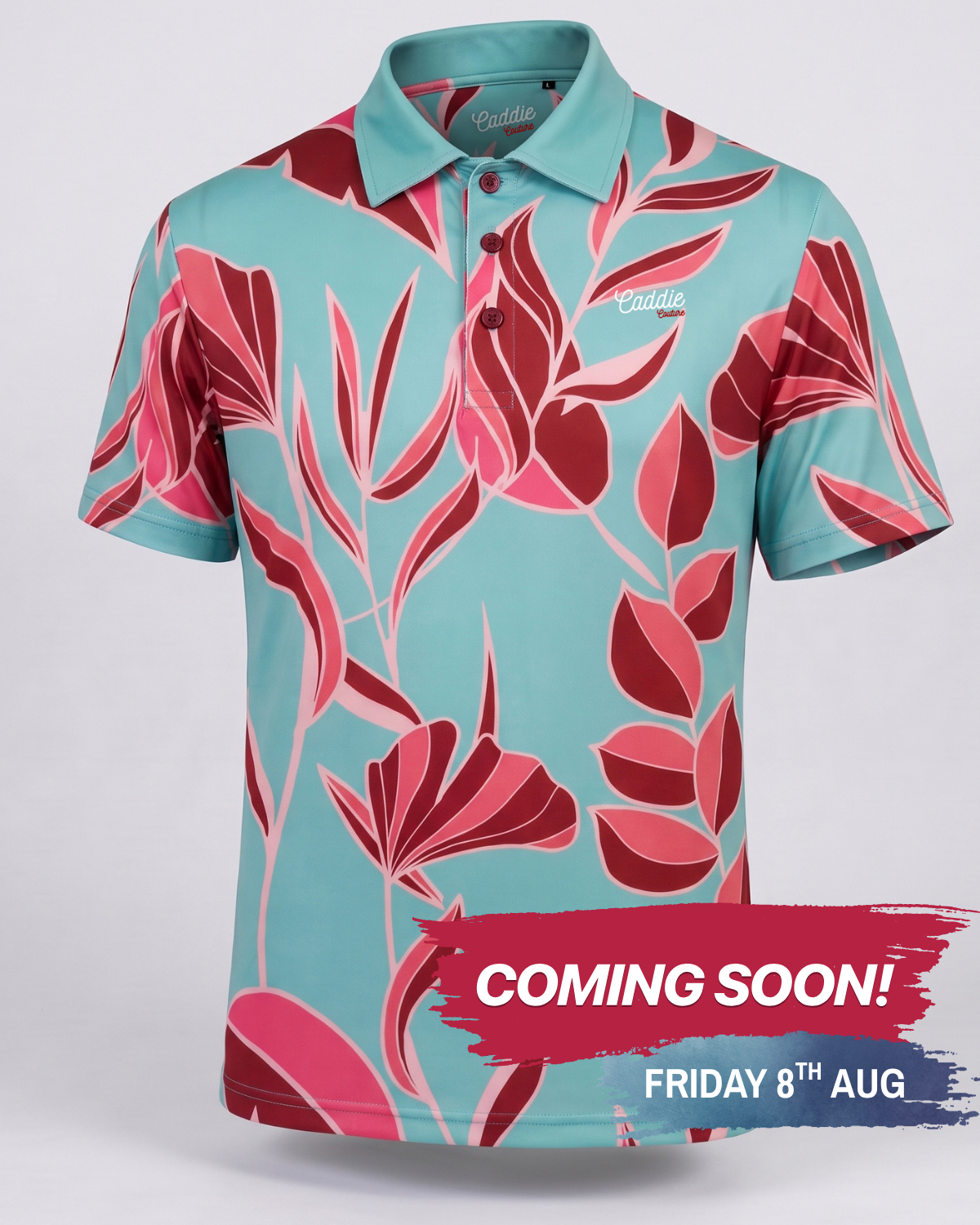 A short-sleeve polo shirt with a vibrant tropical floral pattern in teal, pink, and red, featuring a 'Cuddle' brand logo on the chest and collar, with a 'COMING SOON!' promotional banner overlay at the bottom.