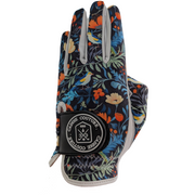 A floral patterned golf glove with multicolored flowers and green leaves on a black background, featuring a white brand label on the wrist.