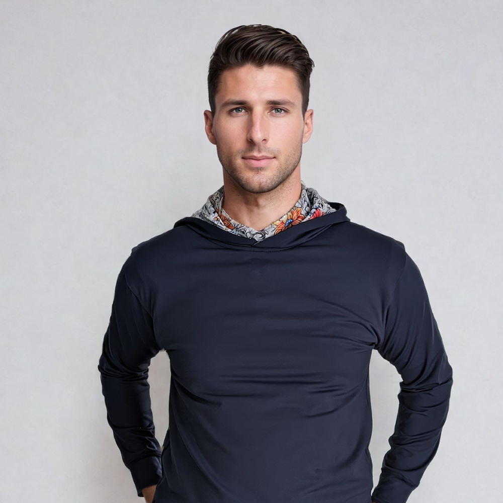 A male model wearing a navy blue hoodie with vintage floral print detailing on the hood.