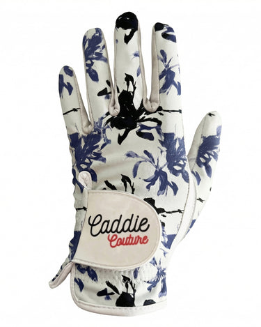 Glove with floral pattern and 'Caddie Couture' branding on a white background