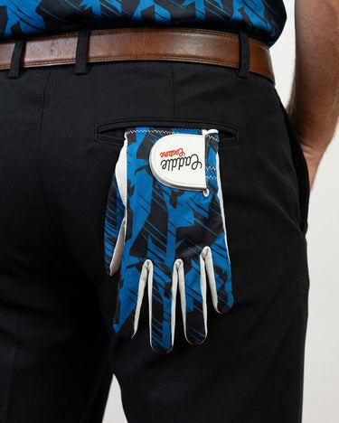 Blue and black patterned golf glove on a person's hand with a white label.