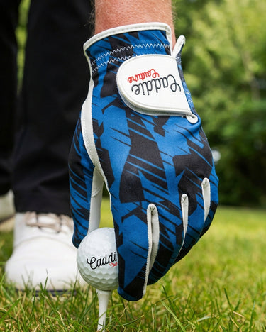 Blue golf glove with white accents on a golf course