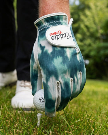 Golf glove with brand logo on a golf course