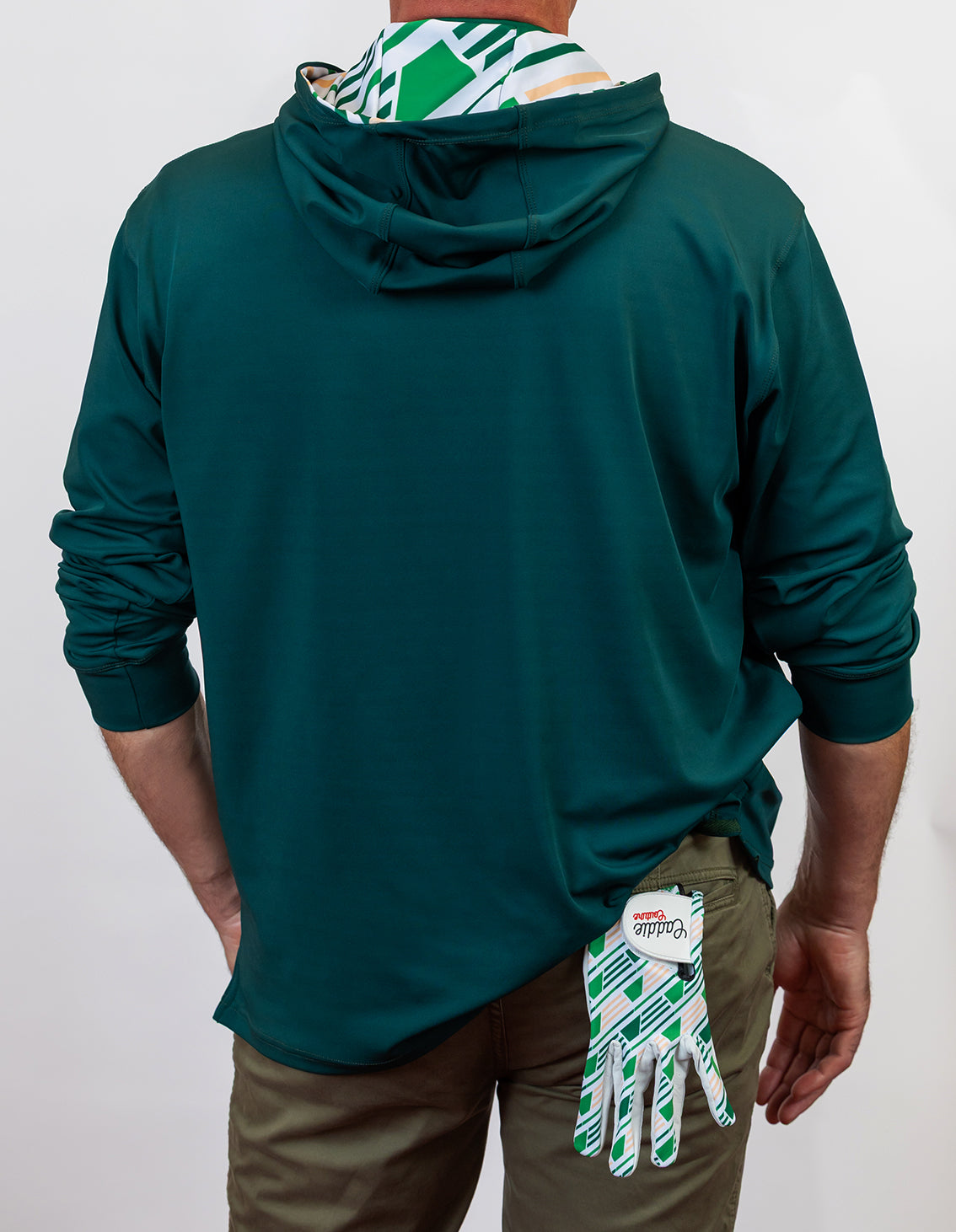 Person wearing a green golf hoodie with a white background