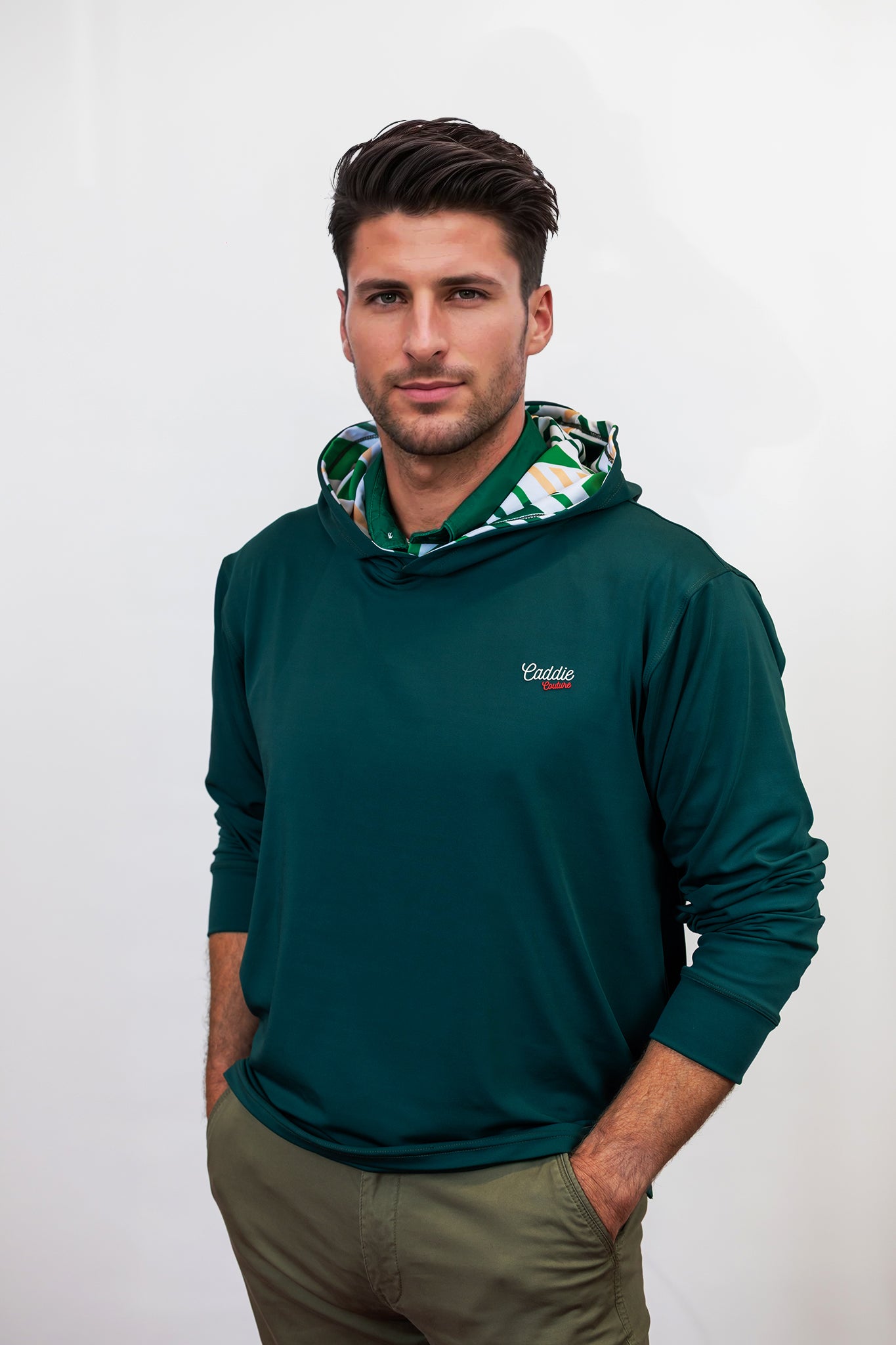 Man wearing a green golf hoodie with a brand logo on a white background