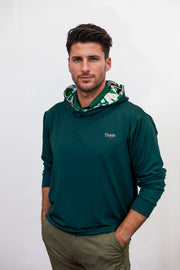 Man wearing a green golf hoodie with a brand logo on a white background