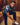 Man tying his shoe in a wooden locker room.