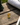 Small trophy-shaped object on a wooden surface with Augusta National Golf Club hat in the background