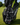 Golf bag with a black and white golf towel featuring 'Caddie' branding on a grassy background.
