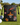 Black drawstring pouch with colorful designs on a golf course