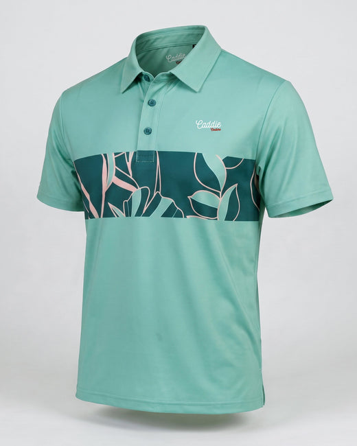 A short-sleeve polo shirt in mint green with a dark teal and pink tropical leaf pattern band across the chest, featuring a small 'Castille' logo on the left chest, displayed on a neutral light gray background.