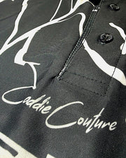 Close-up of a black jacket with white abstract patterns and 'cADDIE cOUTURE' branding.