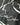 Close-up of a black jacket with white abstract patterns and 'cADDIE cOUTURE' branding.