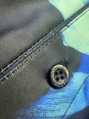 Close-up of a button on a multicolored fabric background